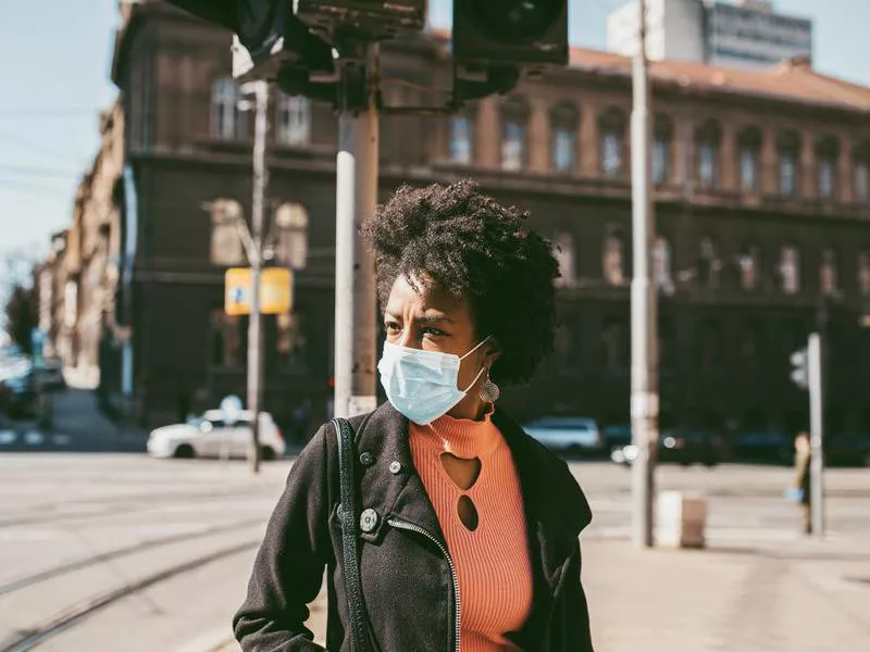 woman outside wearing mask