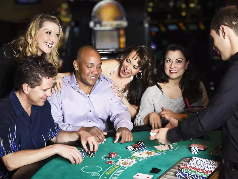 Group of people playing blackjack in a casino