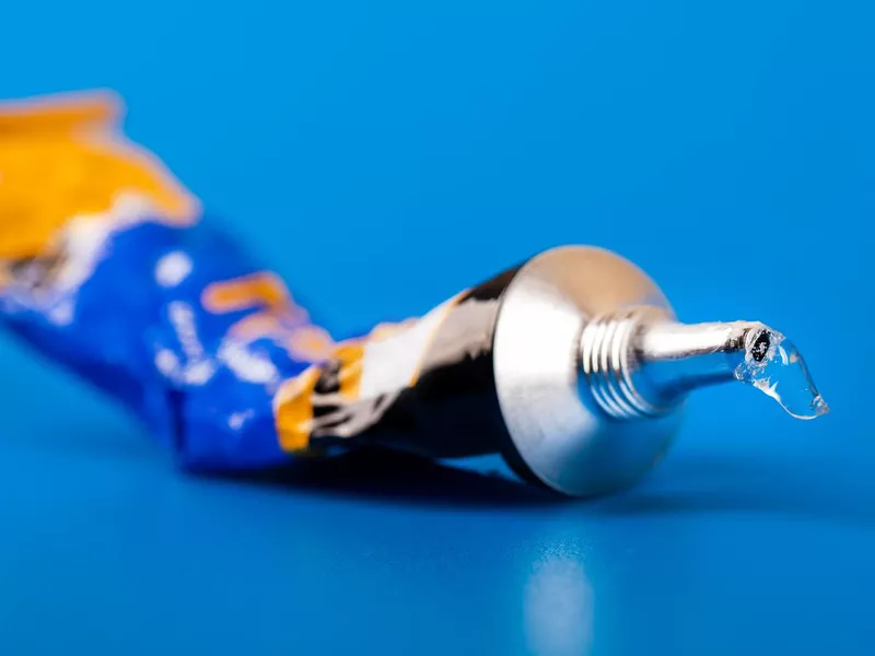 super glue tube on blue background