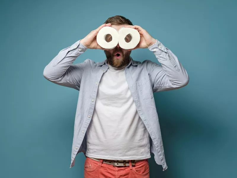 Man holding toilet paper