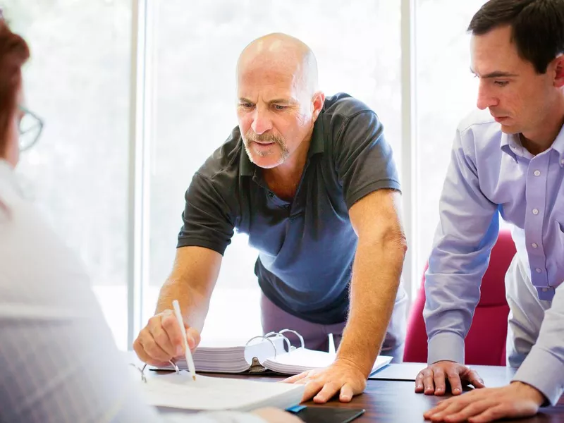 Man aggressively pointing at contract