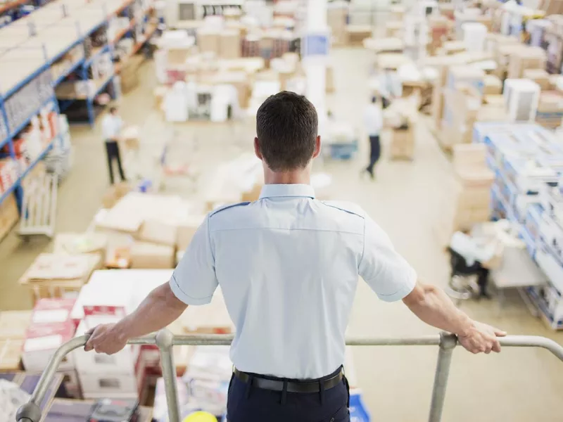 Supervisor monitoring shipping work