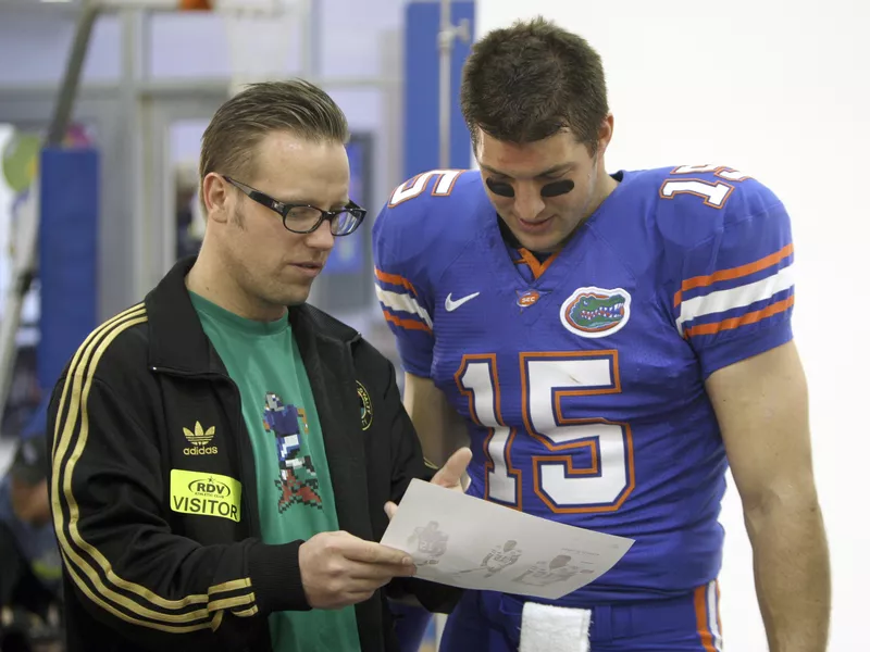 EA Sports creative director Larry Boltutis with Florida quarterback Tim Tebow