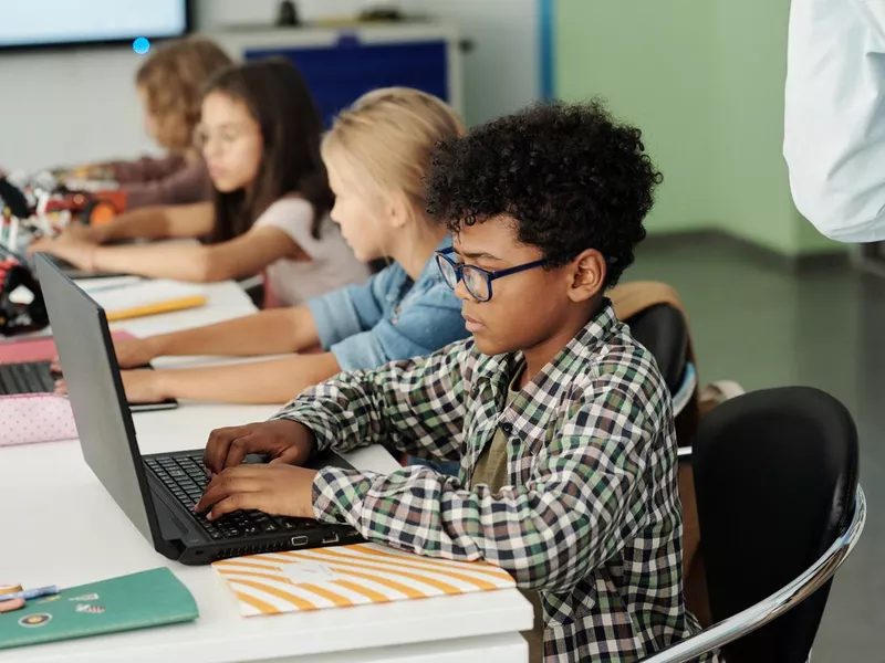 Student working on laptop in class