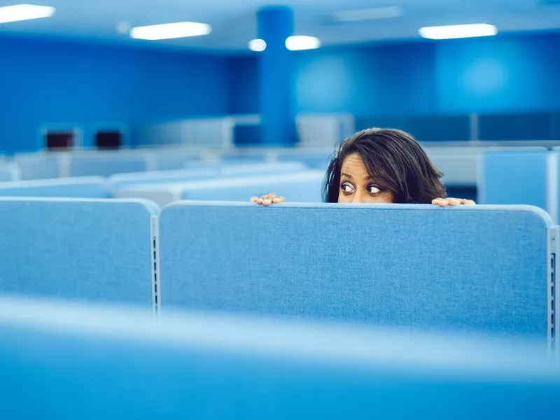 Office worker behind cubicle wall