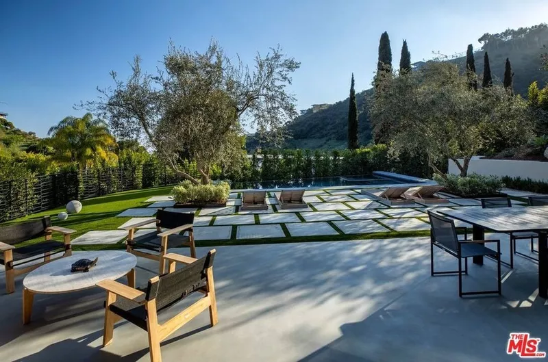 Pool with patio and manicured grounds