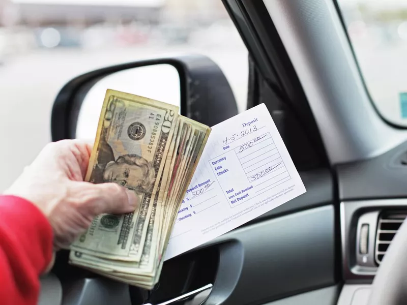 Person holding a large deposit for a car purchase