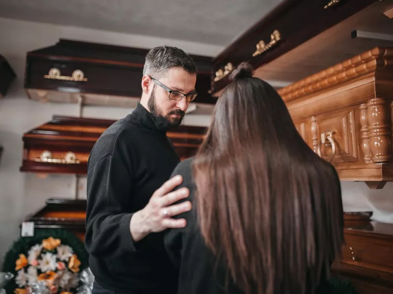 Mortician comforts a widow