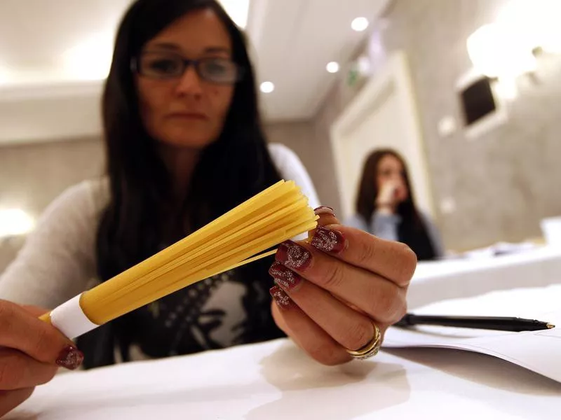 Woman with dried spaghetti