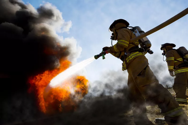 Firefighters extinguishing house fire