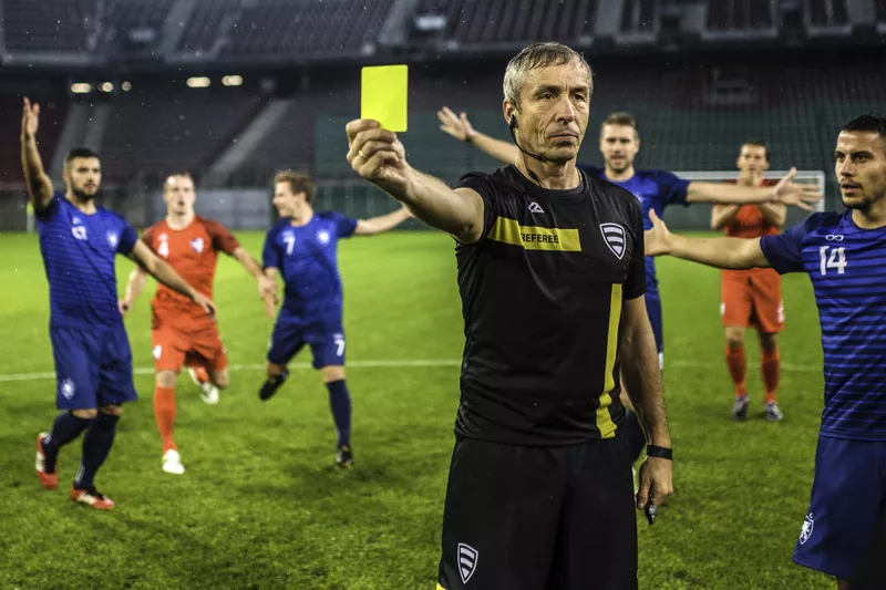 Soccer referee showing yellow card