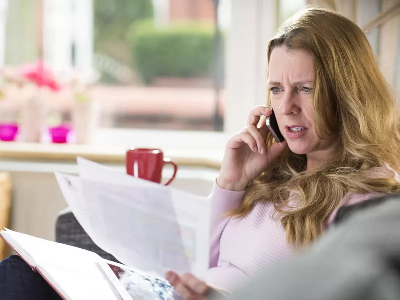 Woman questioning a large bill