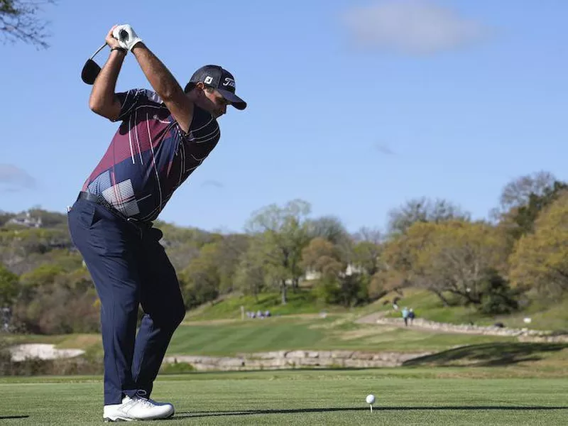 Patrick Reed hits off third tee