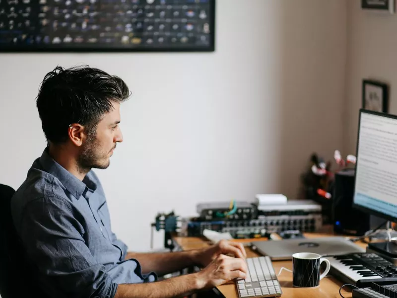 Man at computer proofreading