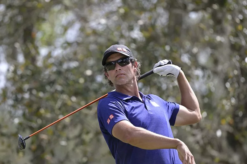 Adam Scott watches after hitting tee shot