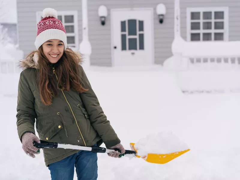 Girl holding a snow shovel