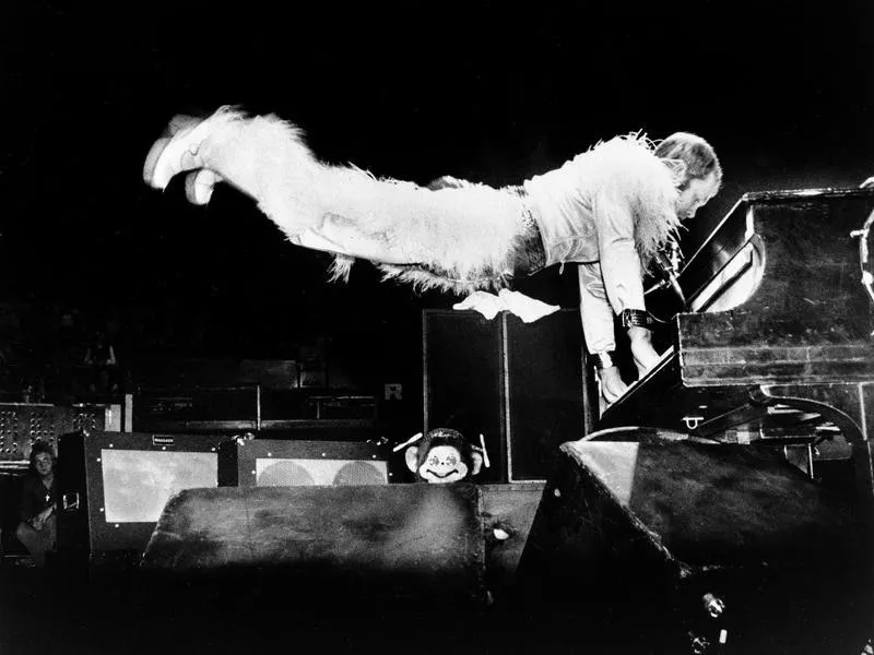 Elton John playing piano in the 1970s