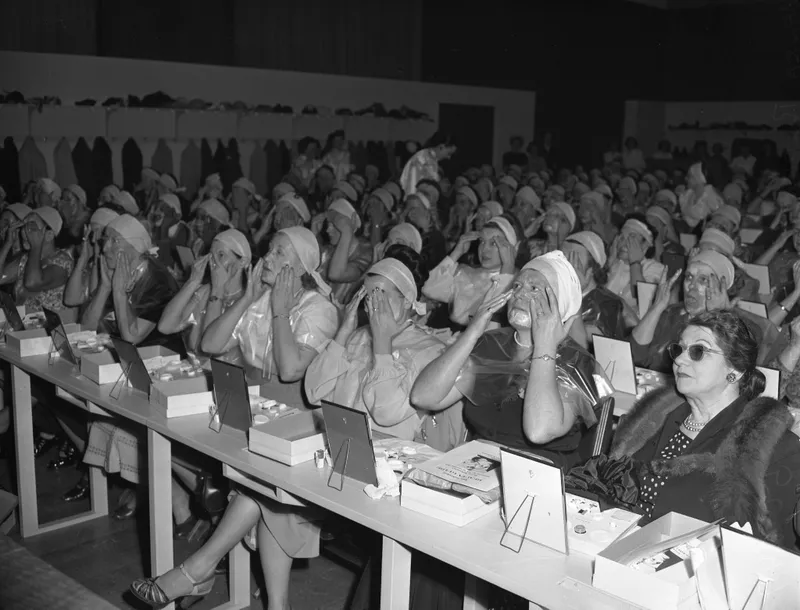 Women putting cream on their faces