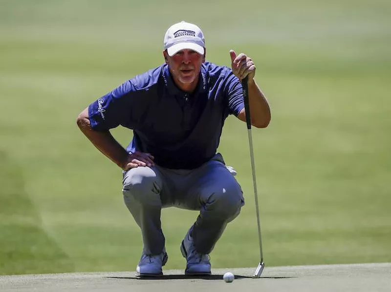 Steve Stricker lines up for his putt on fifth hole