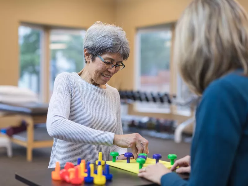 Occupational therapist works with an elderly woman