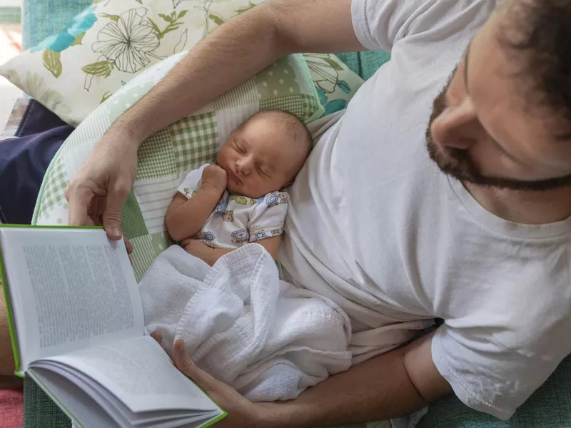 Father Reading with Baby on Lap