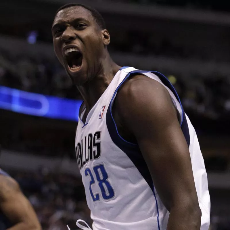 Dallas Mavericks' Ian Mahinmi celebrates a dunk