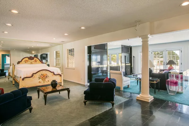 Bedroom with mirrors and media center