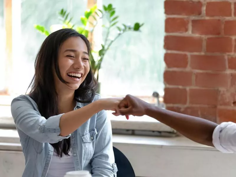 colleagues fist bumping