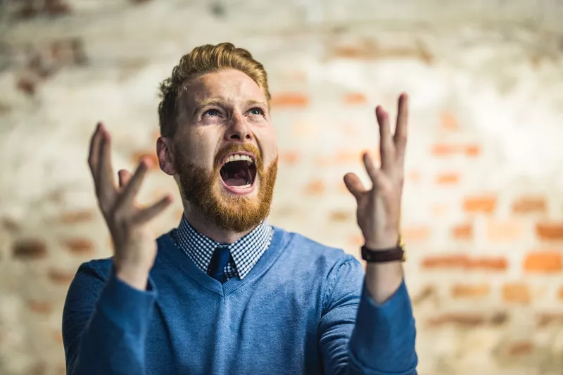 Angry man shouting at sky