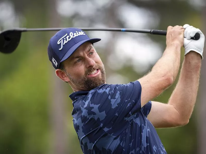 Webb Simpson watches his drive