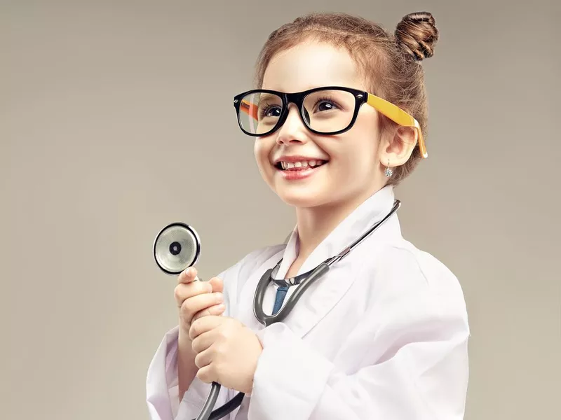 Small preschool girl is playing a doctor