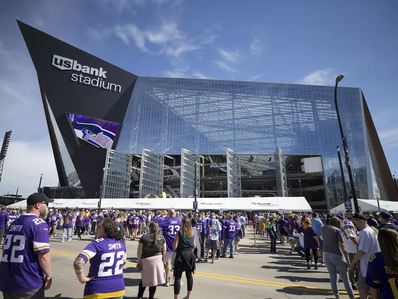 Fans wait outside in line to get in U.S. Bank Stadium