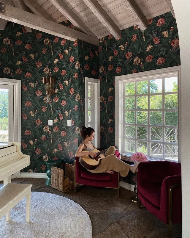 Gomez playing guitar at home