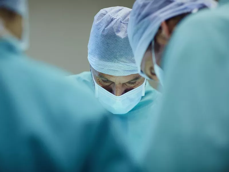 Surgeons working in operating room