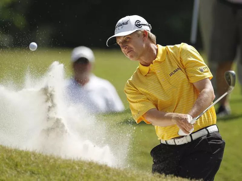 David Toms hits from the sand onto 8th green