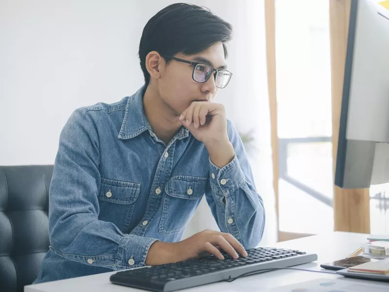 Website tester working at his computer