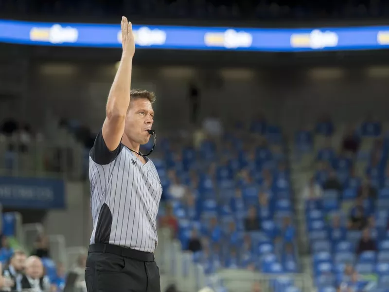 Referee blowing whistle