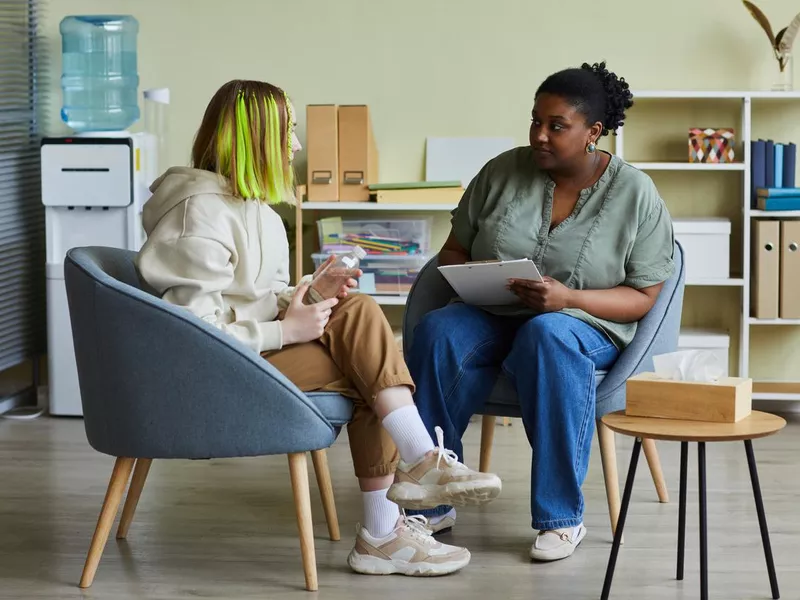 Social worker talking to teen girl