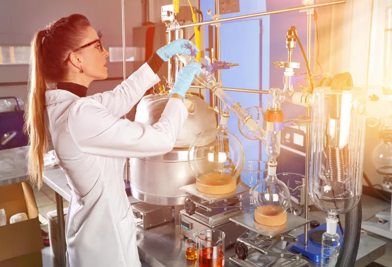 Woman lab technician working with laboratory equipment