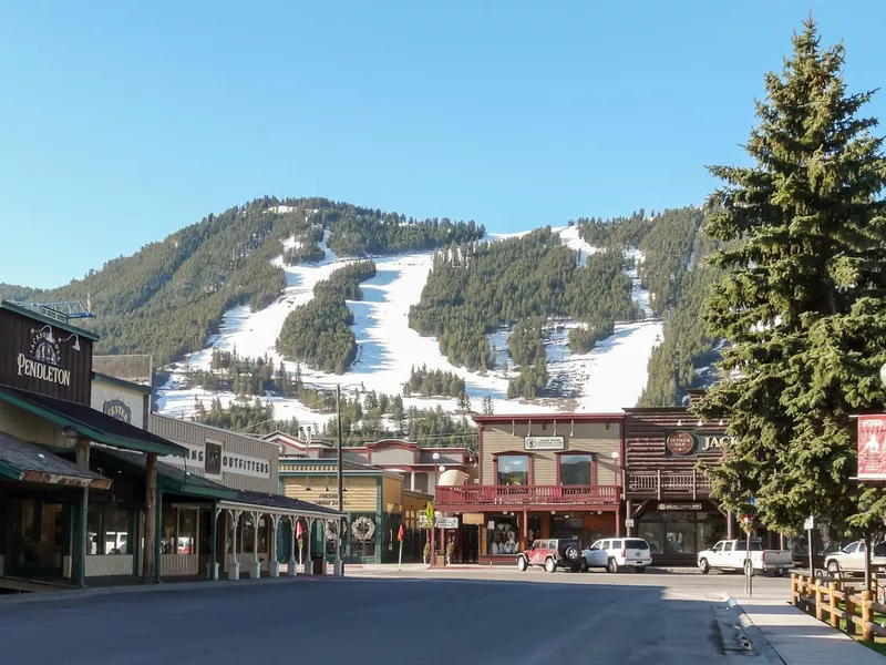 Streets of Jackson Hole with ski slopes at background