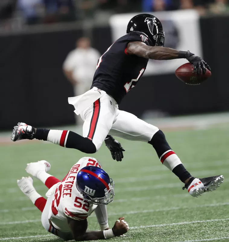 Atlanta Falcons wide receiver Julio Jones runs past New York Giants linebacker Alec Ogletree