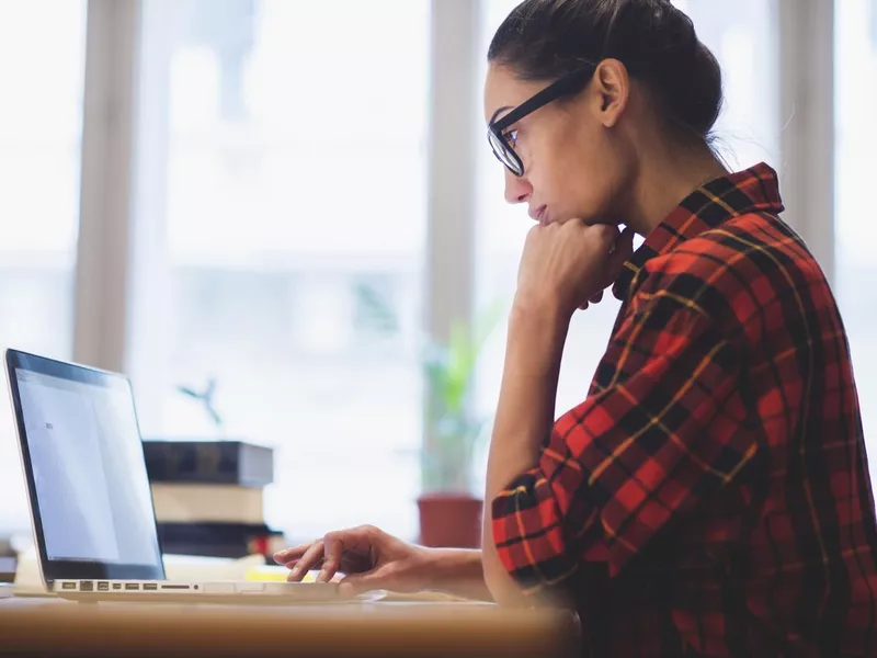 Online researcher looking at computer