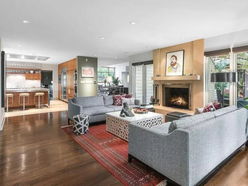 Open floor plan living room with stone fireplace