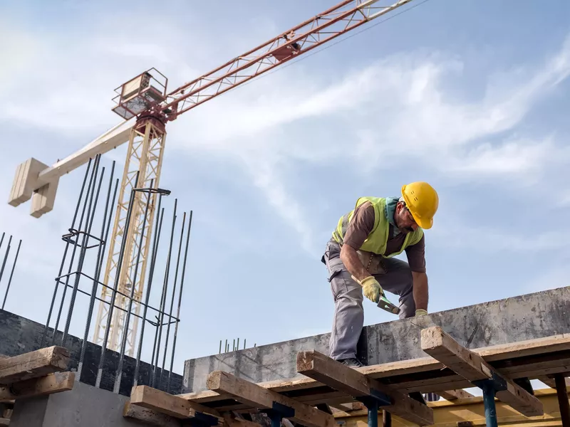 Worker at construction site fixing foundation