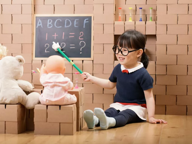 Girl pretend plays as a teacher