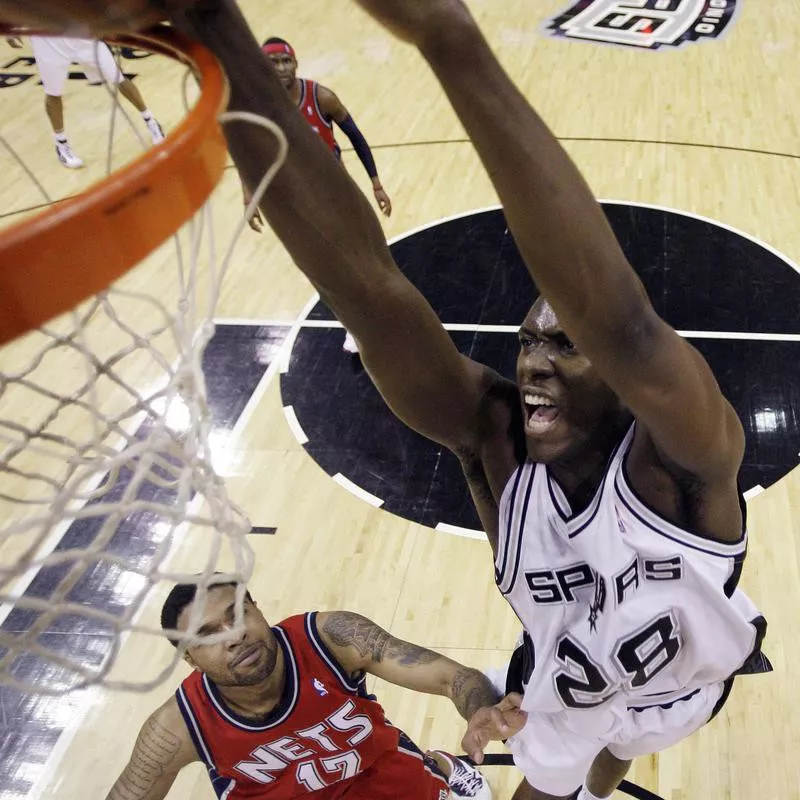 San Antonio Spurs' Ian Mahinmi scores over New Jersey Nets' Chris Douglas-Roberts