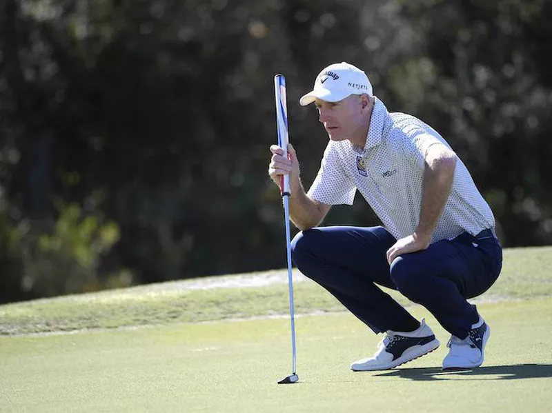 Jim Furyk lines up putt