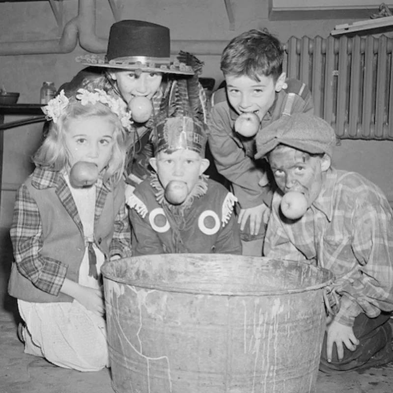 Kids bobbing for apples in the 1920s