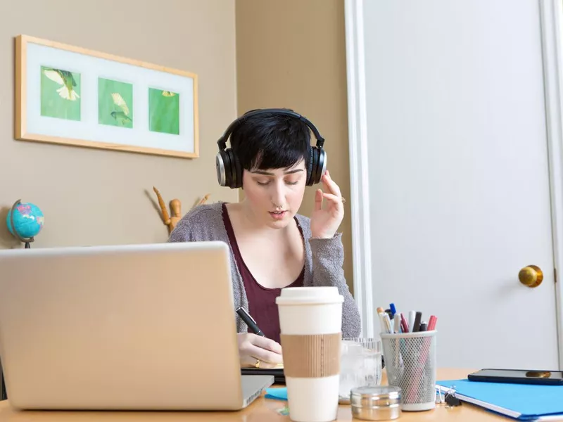 Captioner listening on headphones