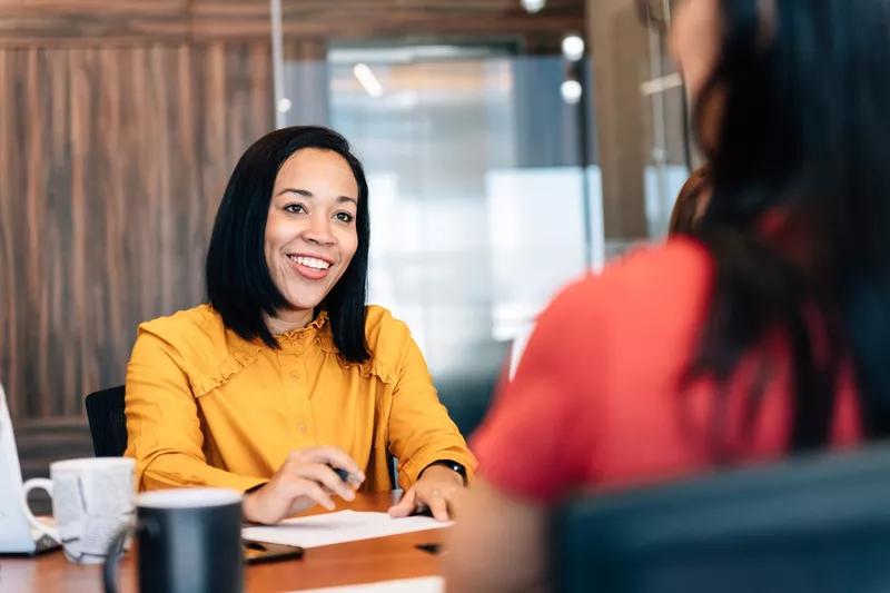 Woman talking at a desk